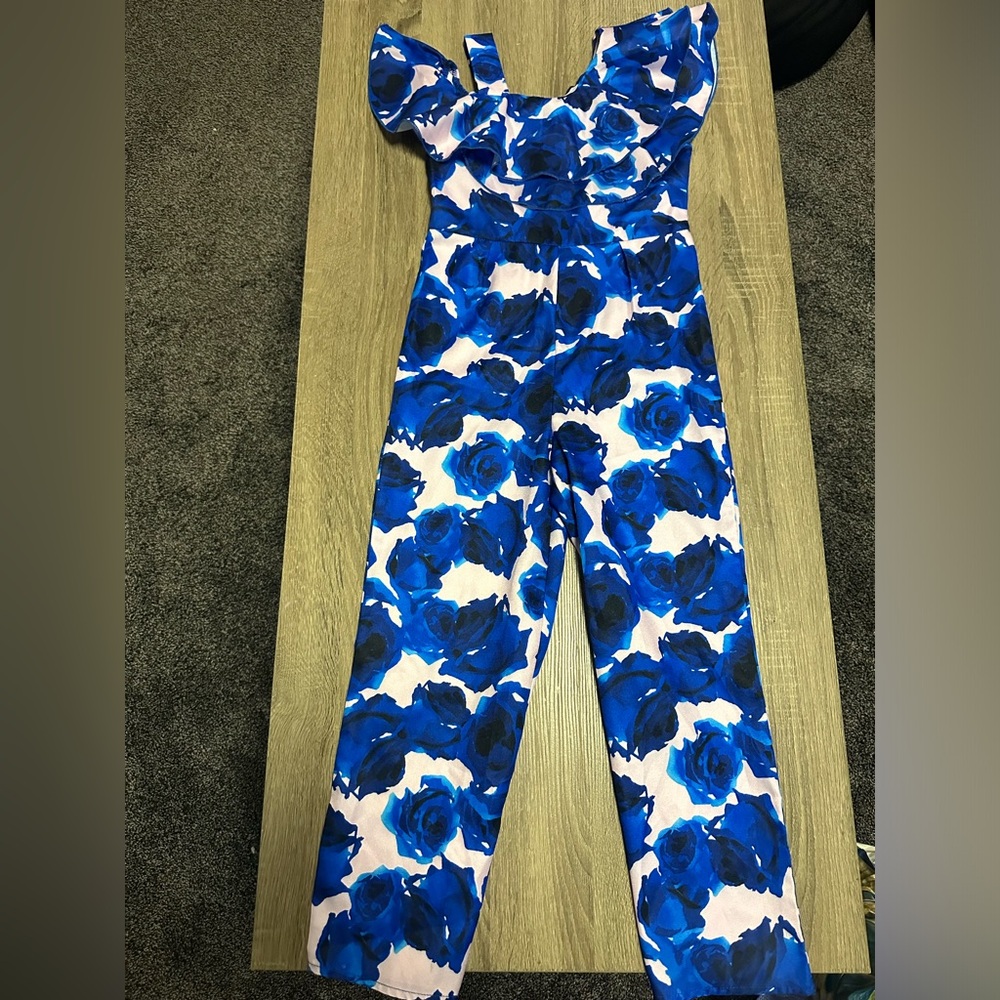 Girls pants romper with ruffle detail and floral design. Satin like material